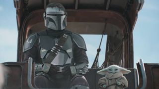 Din Djarin and Baby Yoda sitting together in the Super Bowl TV spot for The Mandalorian and Grogu