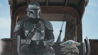 Din Djarin and Baby Yoda sitting together in the Super Bowl TV spot for The Mandalorian and Grogu