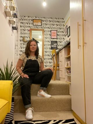 dressing room with bold patterned wallpaper, a dressing table and a zebra rug