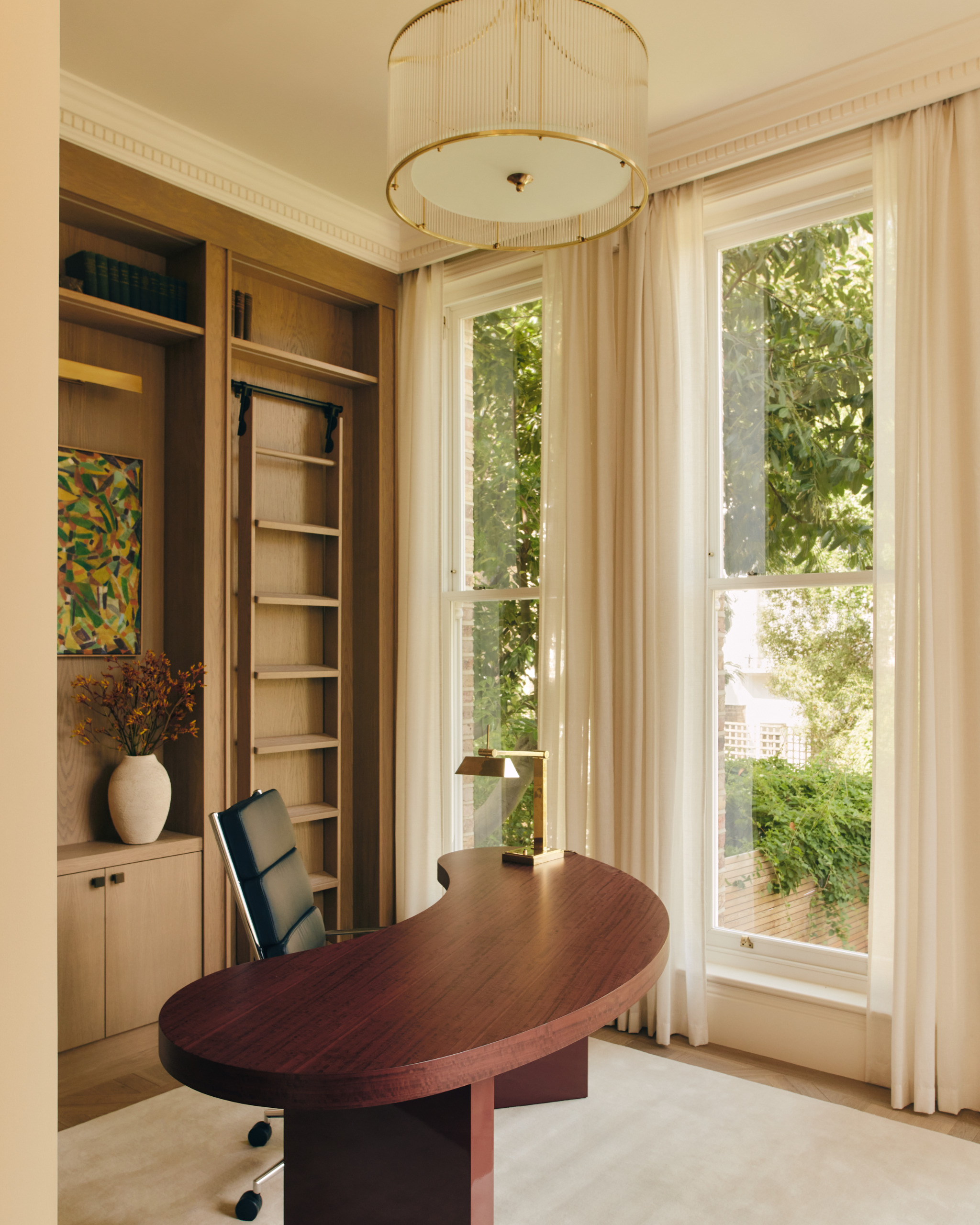 Study with almond desk and leather chair on a cream rug