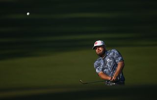 Tyrrell Hatton hits a chip shot