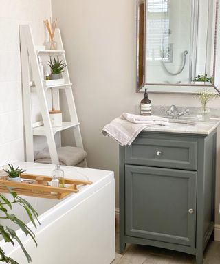 Small bathroom with sage green cabinet