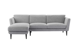 A grey chaise sofa with high legs