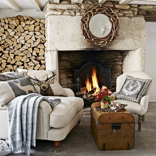 fireplace white walls and armchair with cushion and woods