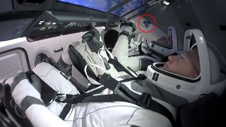 Doug Hurley (in foreground) and Bob Behnken added a Demo-2 mission patch decal (circled in red) to an interior wall aboard the SpaceX Crew Dragon Endeavour, with the hope it will remain with the spacecraft going forward.