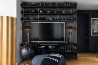 black tv on a black living room wall
