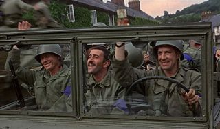 The Dirty Dozen driving through a village and waving at the locals