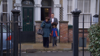 Yolande Trueman holds Raymond's arm as they leave the house with Jack Branning standing behind them.