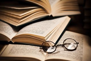 Glasses sitting on open books.