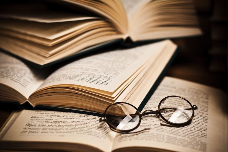 Glasses sitting on open books.