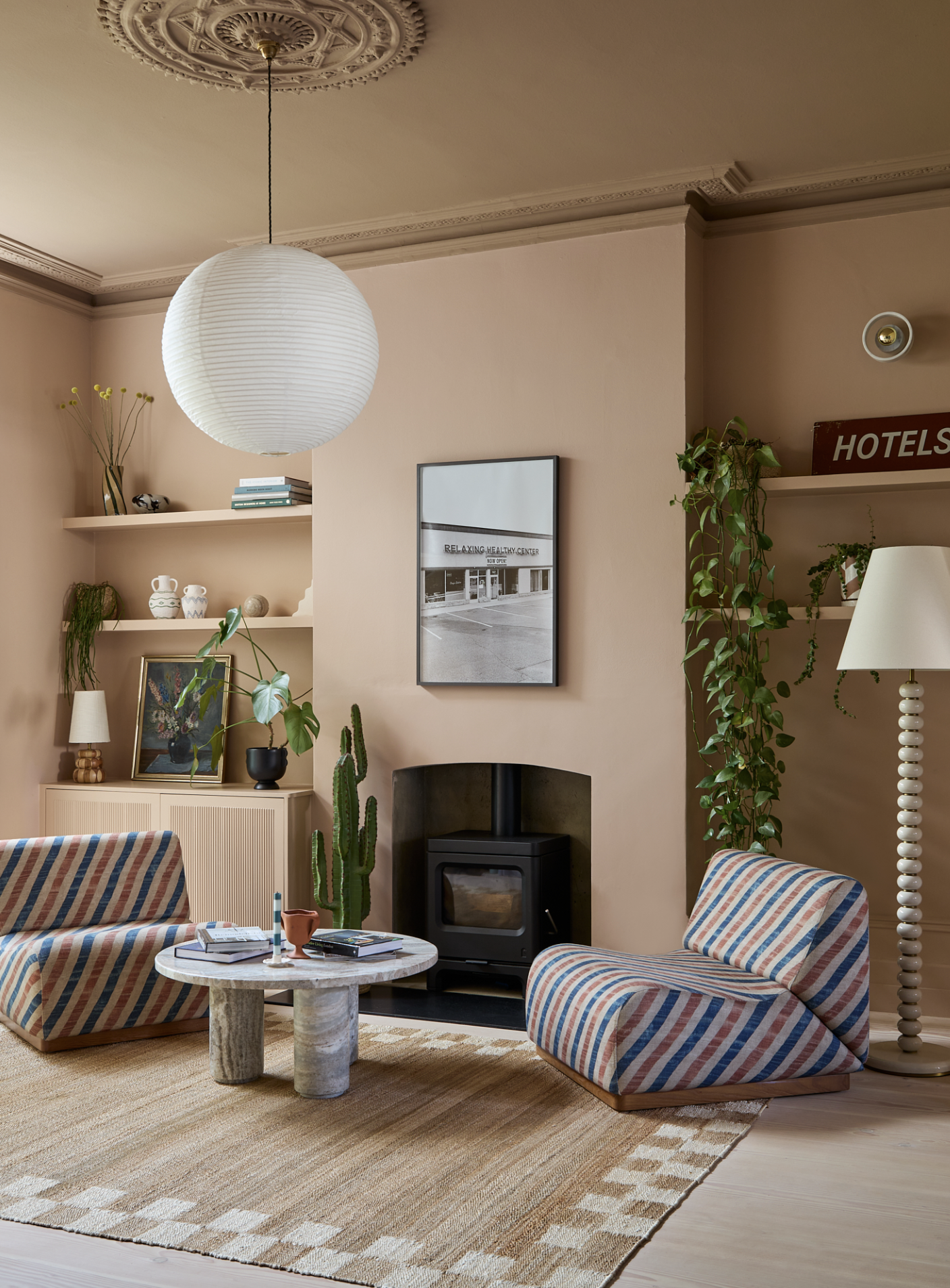 A contemporary living room with floating shelves either side of the fireplace