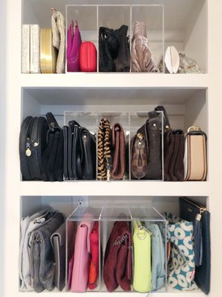 Purses organized with dividers on closet shelves