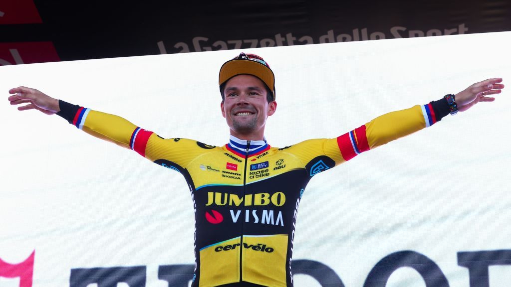 JumboVismas Slovenian rider Primoz Roglic celebrates on the podium after winning the twentieth stage to take the lead of the Giro dItalia 2023 cycling race a 186 km individual time trial between Tarvisio and Monte Lussari on May 27 2023 Photo by Luca Bettini AFP Photo by LUCA BETTINIAFP via Getty Images