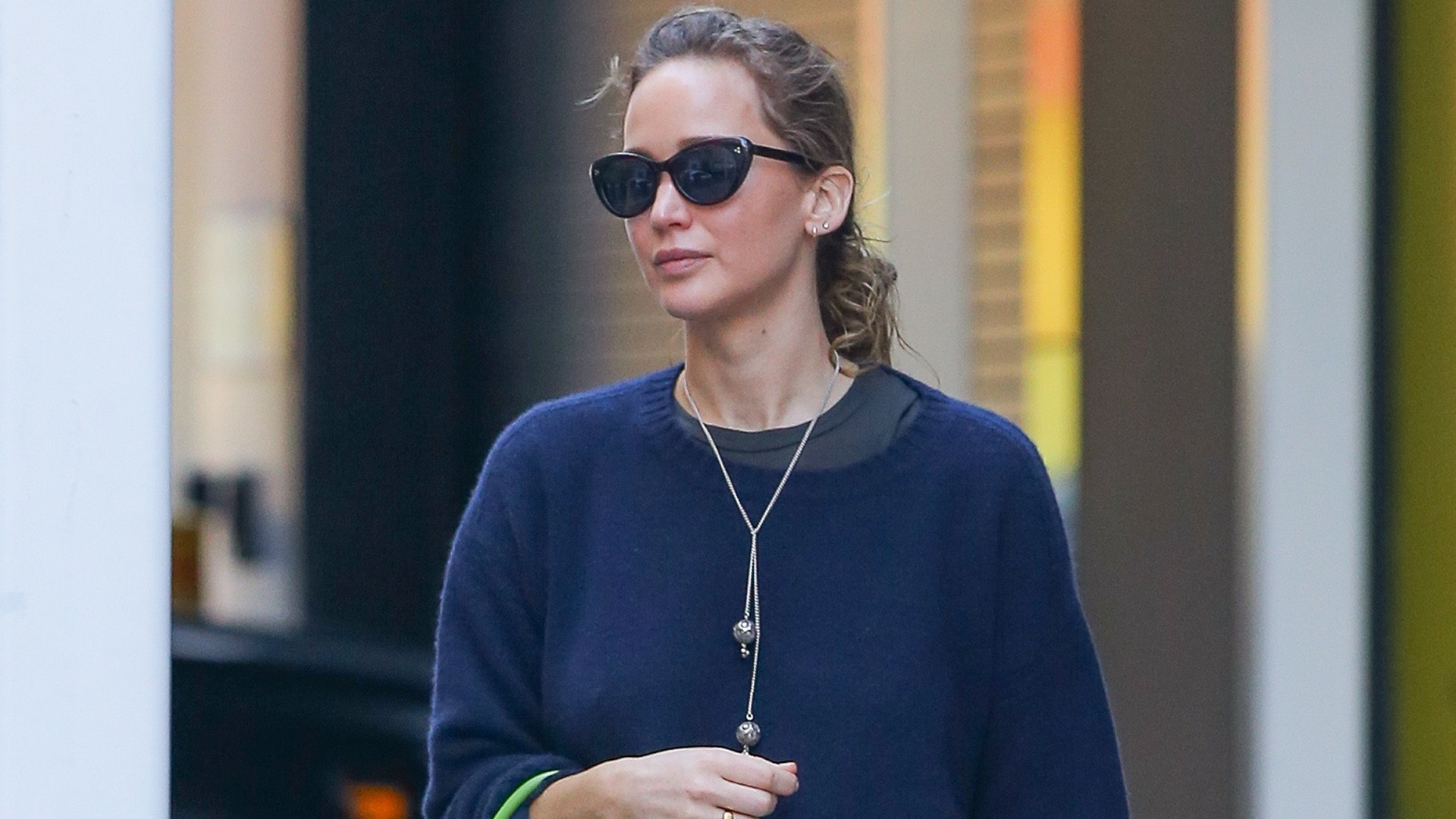 Jennifer Lawrence wore jeans and The Row slippers with a neon green bag, which tapped into the French girl-approved color trend