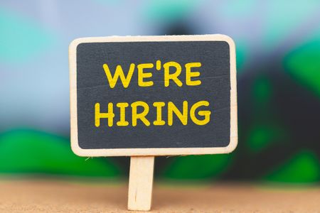 We're hiring sign on chalkboard