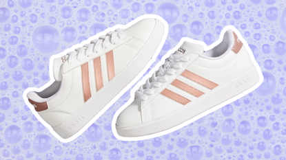 A pair of white and rose gold Adidas shoes on a purple bubble background