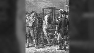Danton looks on defiantly as he is led to his execution