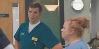 Max looks on as Robyn takes her leave of Holby ED.