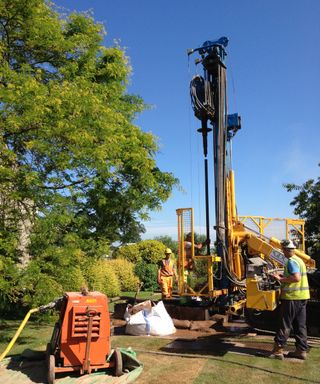 vertical boreholes being dug with large equipment