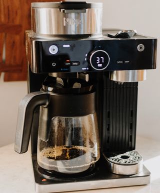 Ninja Espresso & Coffee Barista System making black coffee in glass carafe with plastic handle