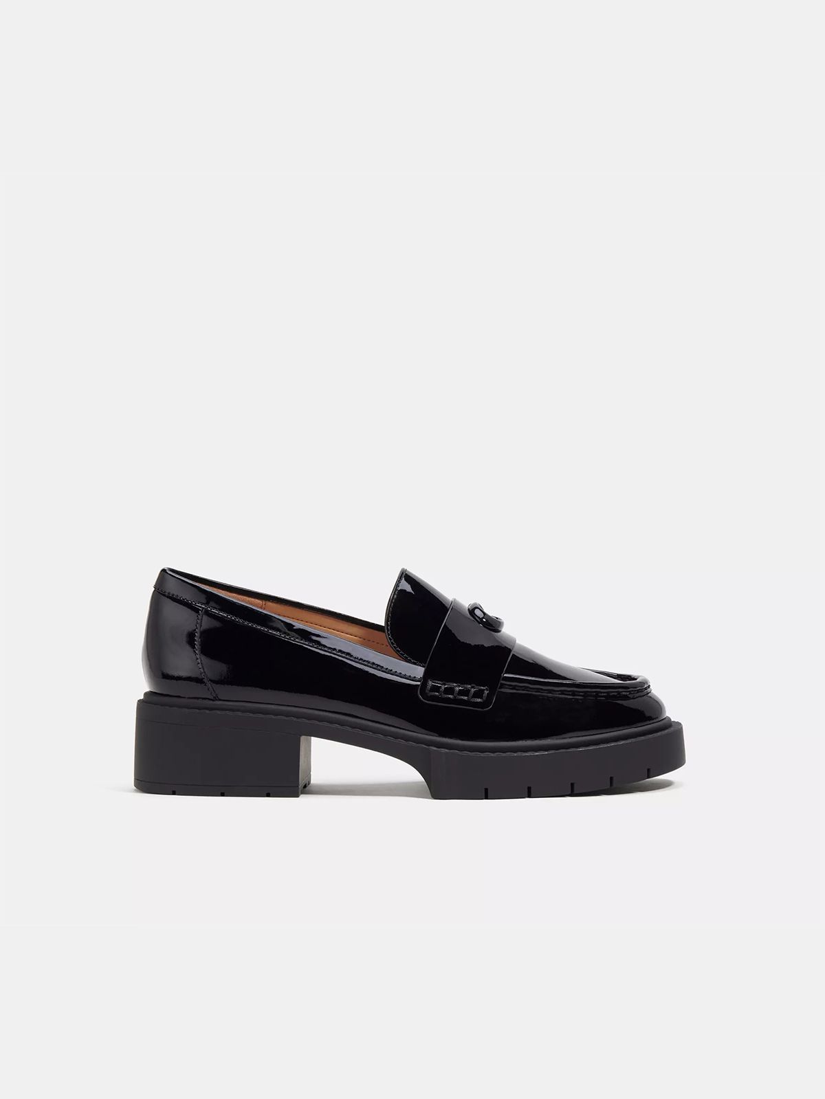 A patent leather black platform loafer.