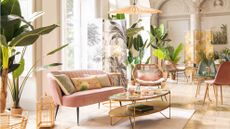 living room sofa pink green plants velvet coffee table chair screen windows