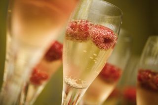 Champagne or sparkling wine with raspberries.