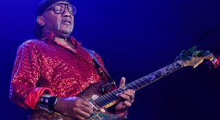 Ernie Isley plays his Fender Zeal Stratocaster onstage wearing, taking a solo – playing the guitar behind his head might have been one of the tricks he picked up from Jimi Hendrix's visits to the family home