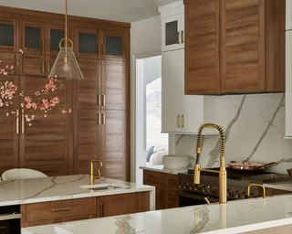 kitchen with wood cabinets, white marble countertops and brass hardware