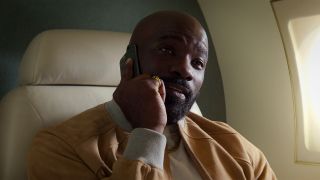 Mike Colter takes a phone call while sitting in a jet in The Union.