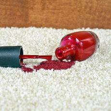 red nail polish spill on a white carpet.