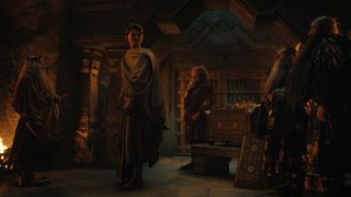 Elrond turns around to look at two dwarf soldiers as King Durin and Prince Durin watch on in The Rings of Power episode 7