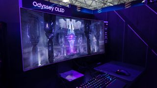 Samsung Odyssey OLED G8 at desk setup with mouse and keyboard