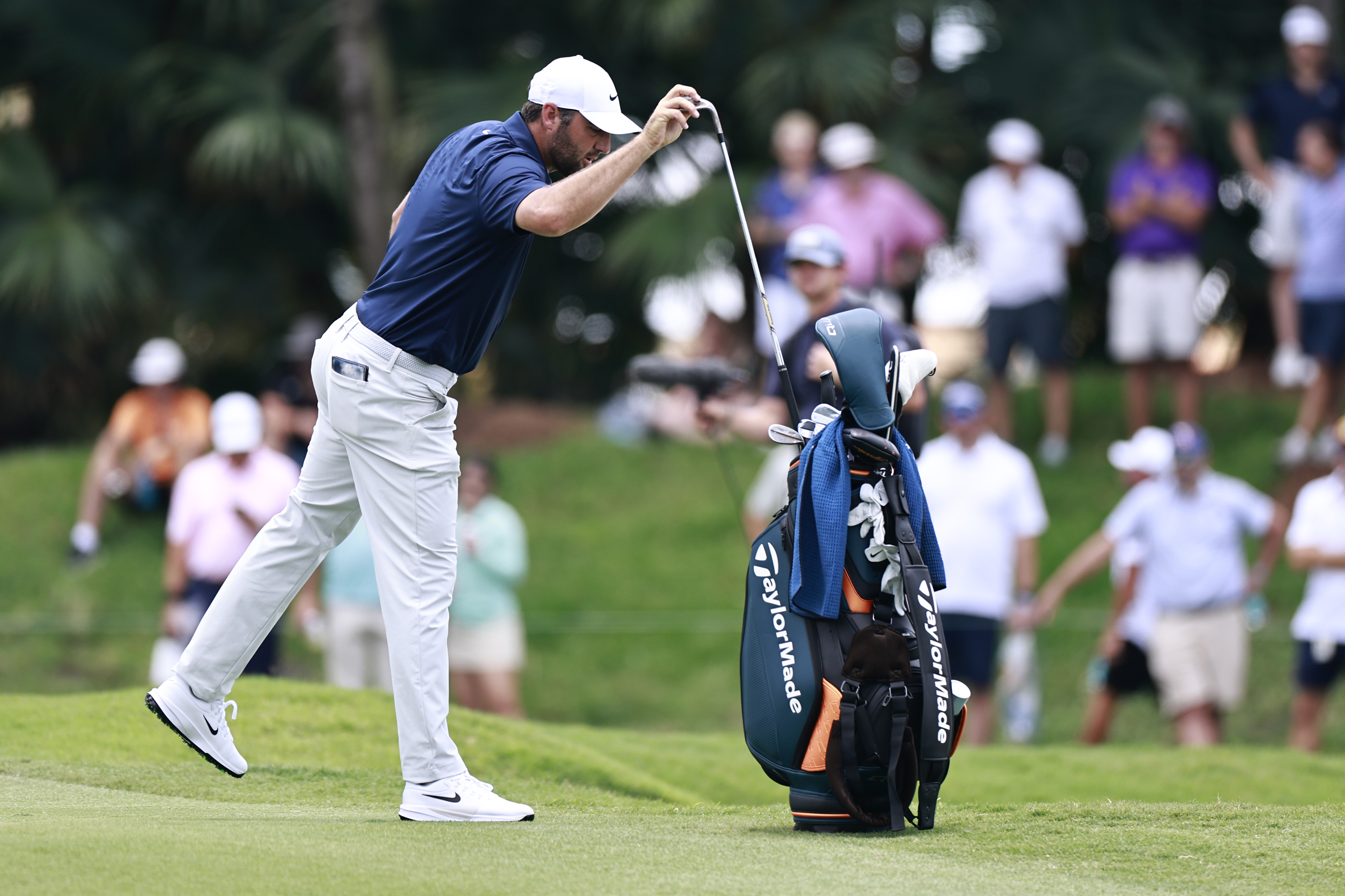 Scottie Scheffler puts his club back in his bag on the 11th hole during the first round of the Cadillac Championship
