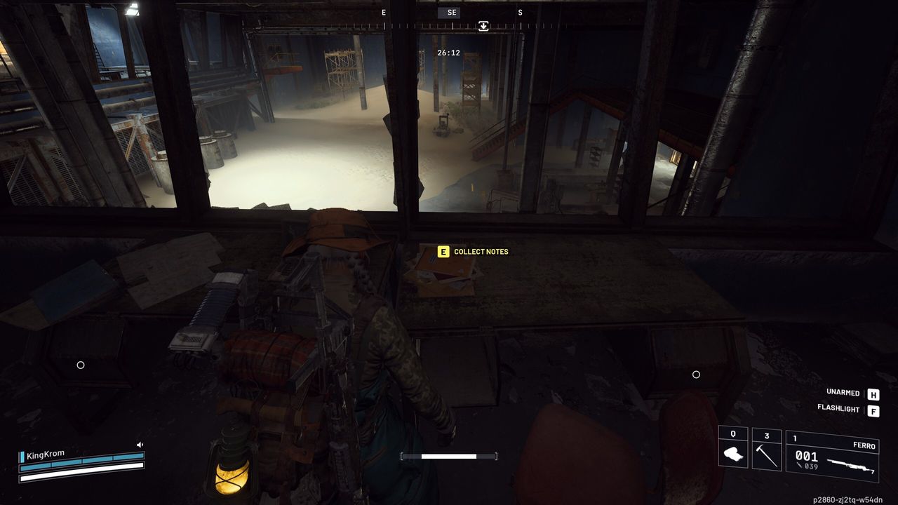 Arc Raiders Lay of the Land: A player looking at the shipping notes on a desk overlooking a dark warehouse.