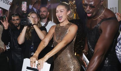 Gigi Hadid at Paris Fashion Week wearing a naked dress and a naked manicure in a crowd