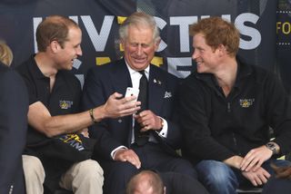 King Charles wears a tweed overcoat while attending church on Christmas Day with wife Queen Camilla, who wears a large black fur hat, and King Charles laughs at a cell phone with sons Prince William and Prince Harry