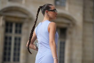 Ginevra Mavilla wears sunglasses, a sleeveless mauve / pastel purple gathered slit dress, , outside Givenchy, during the Womenswear Spring/Summer 2024 as part of Paris Fashion Week on September 28, 2023 in Paris, France.