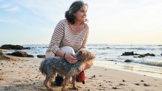 Woman with dog on beach