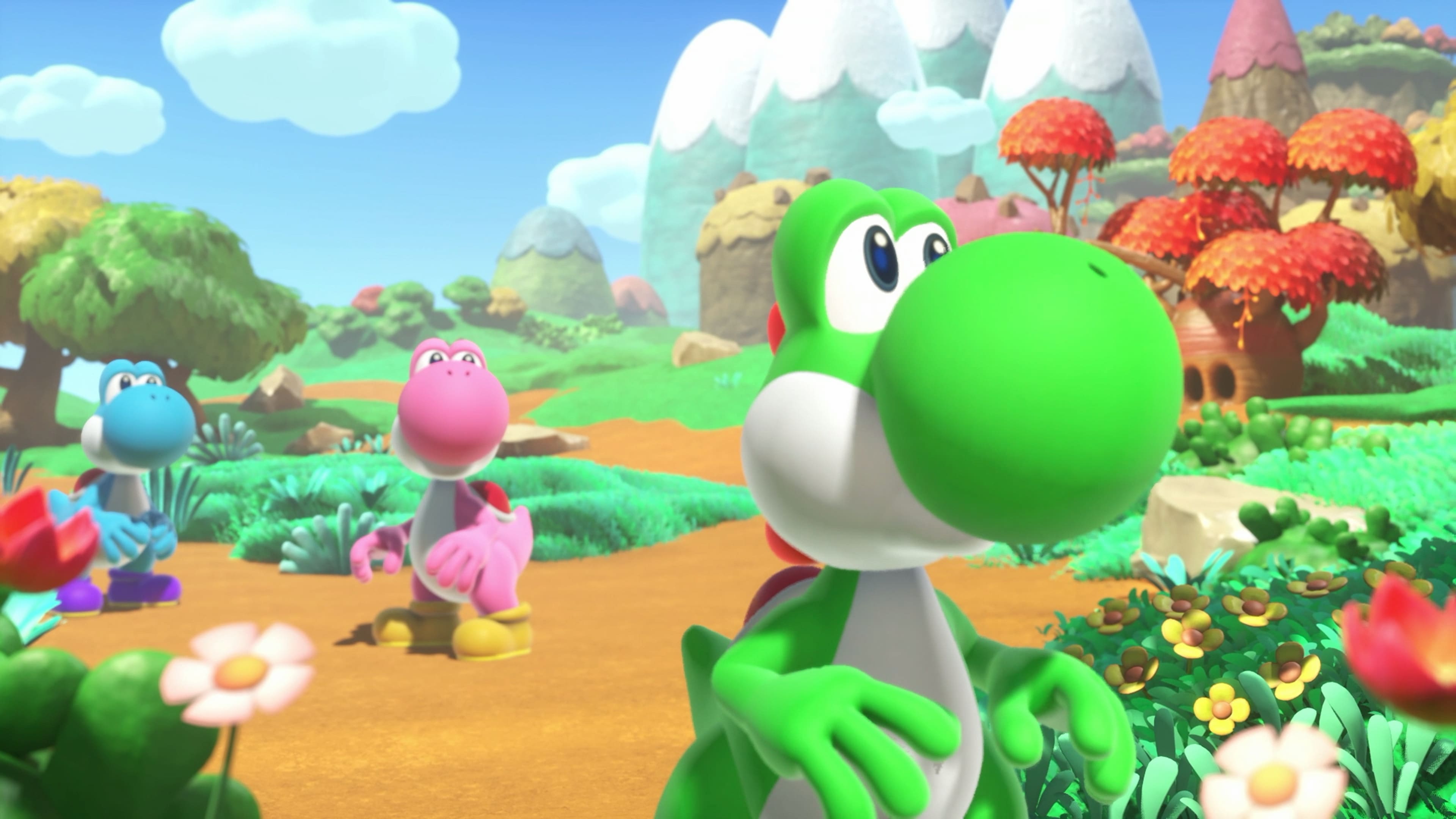 Green, pink, and blue Yoshi look around in Yoshi and the Mysterious Book