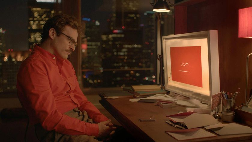 A still from the movie Her showing character Theodore Twombly (played by Joaquin Phoenix) staring at a computer