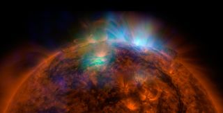 The first image of the sun captured by NASA's Nuclear Spectroscopic Telescope Array (NuSTAR), which is sensitive to high-energy X-ray light. X-rays seen by NuSTAR show up as green and blue in the photo, which is overlaid on an image taken by NASA's Solar 