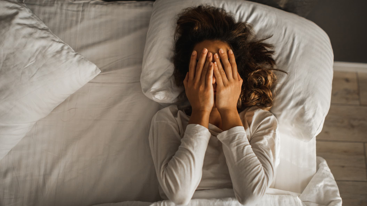 Woman in bed trying to sleep