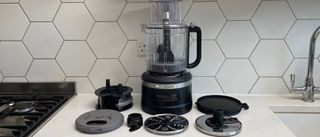 The KitchenAid KFP1319 food processor surrounded by its components