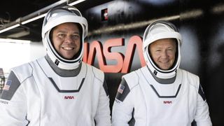 NASA astronauts Bob Behnken (left) and Doug Hurley smile ahead of a final dress rehearsal of their SpaceX Demo-2 launch on a Crew Dragon spacecraft at Pad 39A of NASA's Kennedy Space Center in Florida on May 23, 2020.
