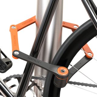 image of the Seatylock Foldylock Compact a folding lock, locking a bike to a bike rack