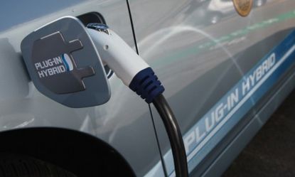 A hybrid car is plugged into a charging station in San Francisco, Calif.: Electric cars may have bigger carbon footprints than their gas-guzzling competitors, according to a new study.