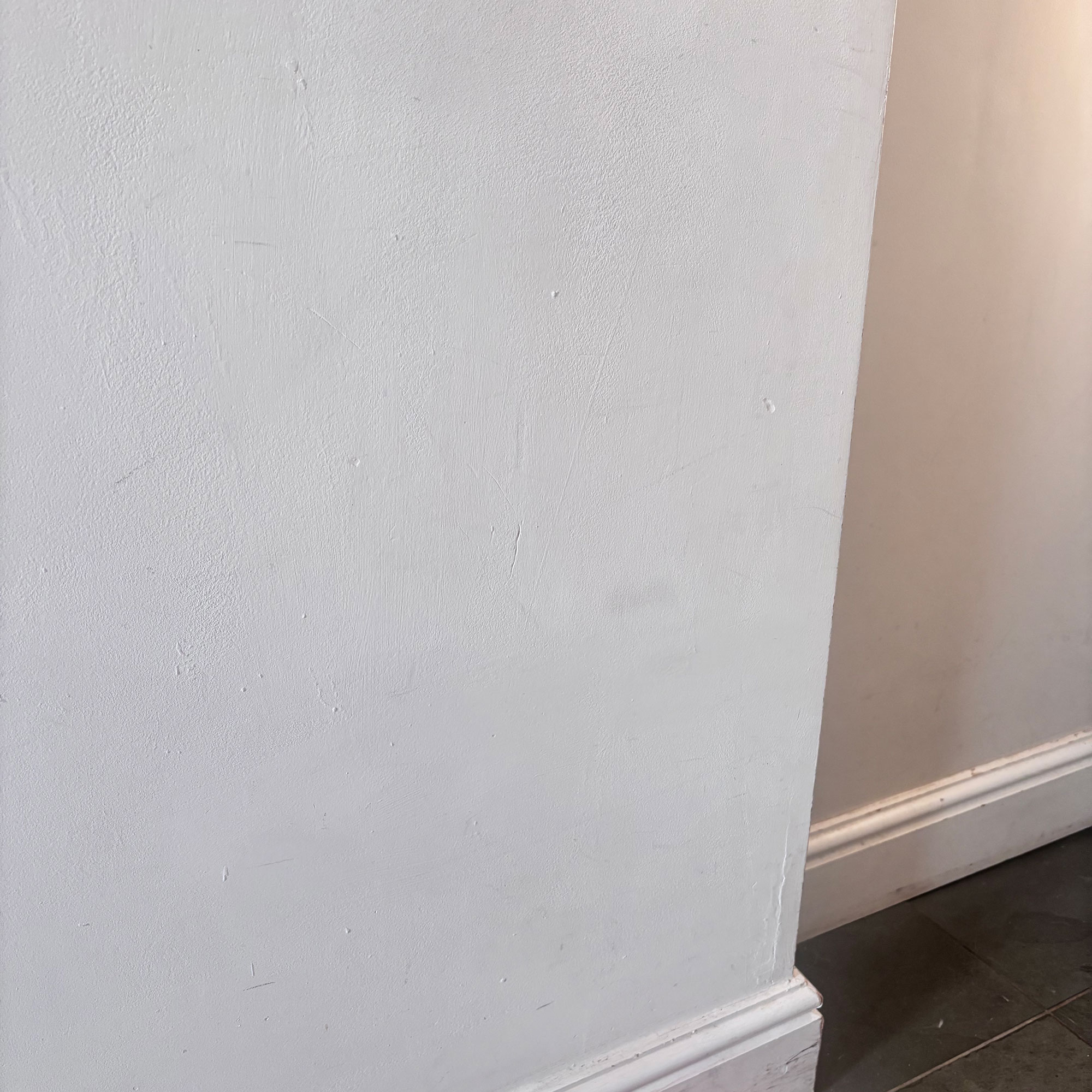 white wall in corner of room