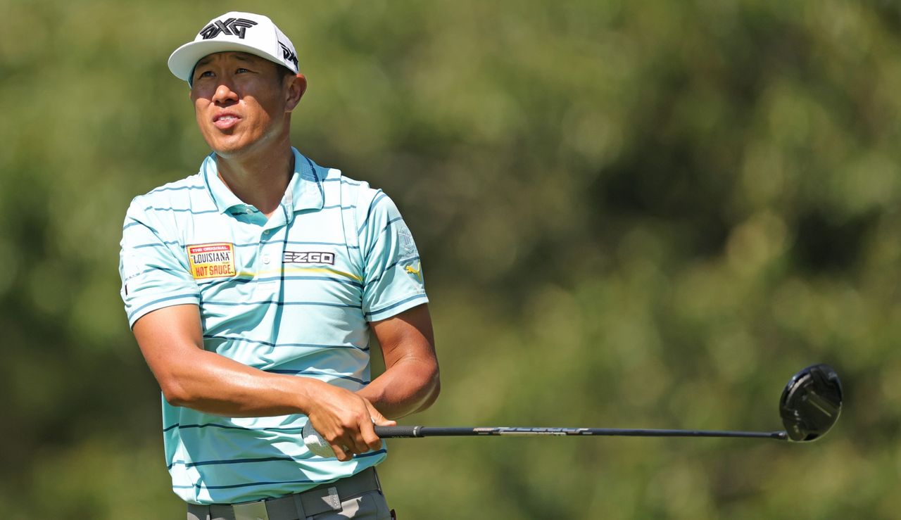 Hahn watches his tee shot with driver in hand