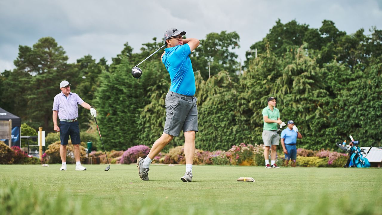 Amateur golfer teeing off at Hankley Common